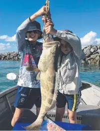  ?? Oscar Smith and Archer Dury were happy to let this big cod swim free near the Western Breakwater ??