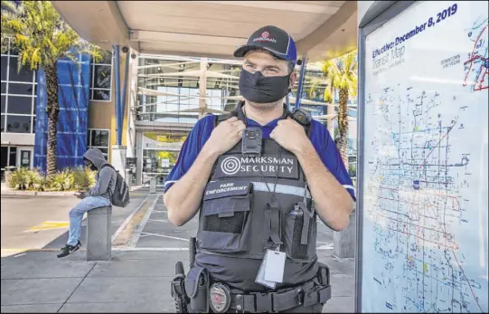  ?? L.E. Baskow Las Vegas Review-Journal@Left_Eye_Images ?? Paul Auger, of Marksman Security, patrols the Bonneville Transit Center in Las Vegas on Aug. 6. Marksman became the Regional Transporta­tion Commission’s new security contractor in July. Body cameras provide live feeds to security management.