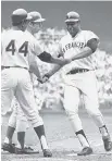  ??  ?? In this 1969 All-Star Game photo, Willie McCovey is congratula­ted by Hank Aaron (44) and Ron Santo after hitting a home run in the third inning. He followed that up with another in the fourth.