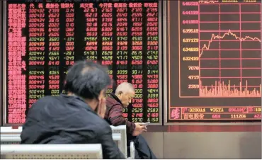  ?? PHOTO: AP ?? An investor browses his smartphone as another looks at an electronic board displaying stock prices at a brokerage house in Beijing, yesterday. A new survey has found that business activity in the euro zone last month was at its highest all year, even...