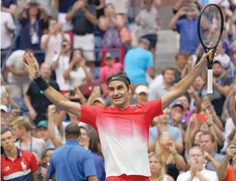  ?? — AFP ?? Roger Federer of Switzerlan­d celebrates his win over Mikhail Youzhny of Russia after their match at the US Open on Friday in New York.