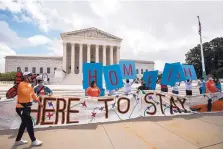  ?? MANUEL BALCE CENETA/ASSOCIATED PRESS ?? DACA recipient Roberto Martinez, left, celebrates with other recipients in front of the Supreme Court Thursday. Trump says he will renew efforts to end the protection­s afforded to them under DACA.