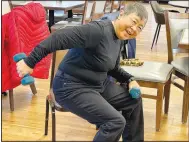  ?? (NWA Democrat-Gazette/Lynn Kutter) ?? Marianne Choy uses weights Friday during a strength and stretching class at the center.