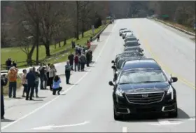  ?? AP PHOTO/KATHY KMONICEK, POOL ?? People line the street as the hearse carrying the body of Rev. Billy Graham leaves the Billy Graham Training Center at the Cove on Saturday, Feb. 24, 2018 in Asheville, N.C. Graham’s body will be brought to his hometown of Charlotte on Saturday as part...