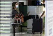  ?? ASSOCIATED PRESS FILE PHOTO ?? A traveler wears a mask as she waits for her flight in Terminal 3 at O’Hare Internatio­nal Airport in Chicago, Nov. 29.