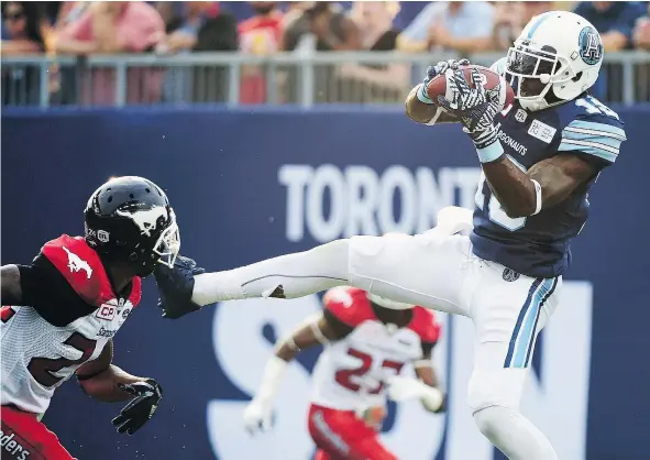  ?? — THE CANADIAN PRESS FILES ?? Argonauts slotback S.J. Green catches a touchdown pass in front of Stampeders defensive back Joe Burnett in Toronto earlier this season. Green is back playing in the CFL a little over a year after suffering a serious knee injury.
