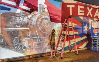  ?? Mike Baxter ?? Artist Beth Mankin works into the night to put the final touches on Tomball’s first mural. The piece has been delayed several times because of rains, but it should be finished by the end of the month.