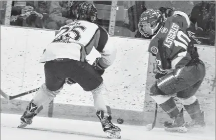  ?? SALTWIRE NETWORK FILE PHOTO/DIANE CROCKER ?? In this January, 2018 file photo, the Western Kings’ Skylar Coates (25) and Andrew Stuckless of the East Coast Blizzard (right) contend for the puck during their provincial major midget hockey game at the Corner Brook Civic Centre. There is a move within Canada to change the traditiona­l names of hockey age groups, and for some people, there is a particular focus on eliminatin­g the term “midget.”