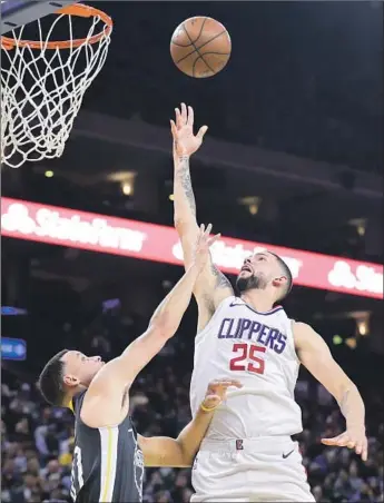  ?? Marcio Jose Sanchez Associated Press ?? CLIPPERS GUARD Austin Rivers shoots over Golden State Warriors defender Stephen Curry during the first half, scoring two of his 14 points. Curry scored a game-high 44 points.