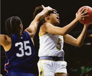  ?? Michael Caterina / Associated Press ?? Notre Dame’s Olivia Miles (5) tries to drive past UConn’s Azzi Fudd on Sunday.