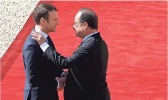  ??  ?? Outgoing President François Hollande, right, is escorted by his successor Emmanuel Macron as he leaves the Élysée presidenti­al palace Sunday before Macron’s formal inaugurati­on. POOL PHOTO BY PATRICK KOVARIK