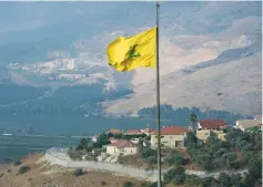  ?? ( Aziz Taher/ Reuters) ?? IN MANY ways, Hezbollah is operating as ‘ a state within a state’ in Lebanon. Pictured: A Hezbollah flag flutters in the southern Lebanese village of Khiam, near the border with Israel, in July.