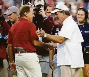  ?? Bob Levey / TNS 2021 ?? Alabama head coach Nick Saban (left) and Texas A&M head coach Jimbo Fisher have traded barbs over this year’s recruiting class.