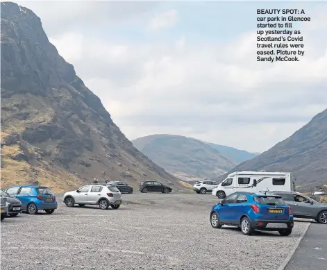 ??  ?? BEAUTY SPOT: A car park in Glencoe started to fill up yesterday as Scotland’s Covid travel rules were eased. Picture by Sandy McCook.