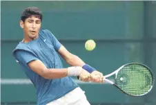  ?? — Photo courtesy of Dr Wee Thian Yew (SLTA) ?? India’s Tavish Pahwa plays a return to Lucas Han of Australia in the first singles of the quarterfin­als.