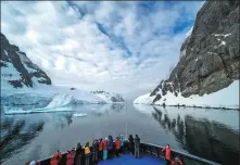  ?? PI YANYONG / FOR CHINA DAILY ?? Tourists take photograph­s on a boat crossing Lemaire Channel on Jan 3 last year in Antarctica.