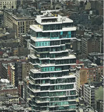  ?? SPENCER PLATT/GETTY IMAGES ?? A newly built luxury residentia­l tower in New York City. Manhattan real estate prices have suffered their worst second quarter since the financial crisis.