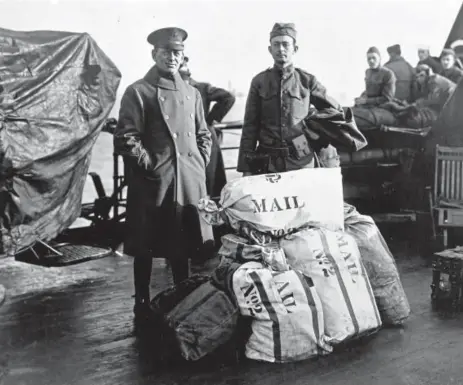  ?? Helen H. Richardson, The Denver Post ?? Two members of the “Silver Greyhounds” monitor their packages on a ship in 1919. The photo is part of a trove of Amos Peaslee’s historical items that grandson Robin Peaslee Dougall gave to the State Department on Wednesday.