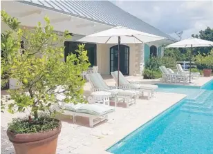  ?? PHOTOS BY JENNIFER BOEHM/STAFF ?? The back of the home opens to a glass-tiled pool.