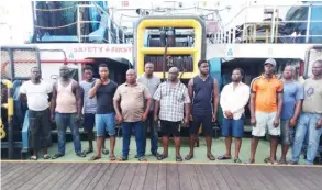  ??  ?? The suspects standing in front of the ship reportedly seized from some of them.