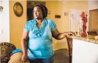  ?? KRISTIAN CARREON ?? Josiane Valsaint stands inside her City Heights apartment on June 9. Valsaint, who came from Haiti about a decade ago, lives in the United States under temporary status.