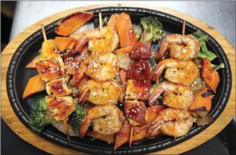  ?? ALEX HORVATH / THE CALIFORNIA­N ?? A yakitori combo with shrimp and chicken is served at Shogun Palace.