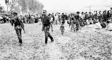  ?? — AFP photo ?? File photo shows members of the Border Guard Bangladesh (BGB) are seen on duty as they detain hundreds of Rohingya refugees in an open area after they crossed the border in Teknaf.