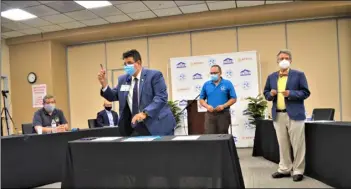  ?? PHOTO JULIO MORALES ?? ECRMC CEO Dr. Adolphe Edward signs a memorandum of understand­ing establishi­ng a partnershi­p with the Mexican Consulate in Calexico’s Ventanilla de Salud program on Wednesday at ECRMC.