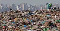  ?? - Reuters ?? EKE OUT A LIVING: A man works at ‘Lixao da Estrutural’, Latin America’s largest rubbish dump, in Brasilia, Brazil, January 19, 2018.