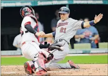  ?? [TONY DEJAK/THE ASSOCIATED PRESS] ?? The Twins’ Jason Castro slides in to score ahead of the tag by Indians catcher Roberto Perez during a four-run second inning for Minnesota.