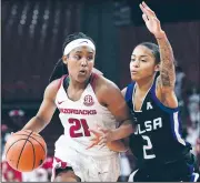  ?? NWA Democrat-Gazette file photo/J.T. WAMPLER ?? Arkansas’ Devin Cosper (left) drives past Tulsa’s Tatyana Perez on Dec. 10. The Razorbacks still don’t know if Cosper will be able to play tonight against South Carolina.