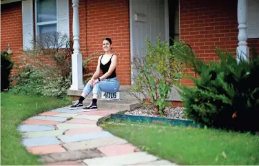  ?? SARAH PHIPPS/THE OKLAHOMAN ?? Katherine Metcalfe, a first-time homeowner, sits in front of her home in northwest Oklahoma City.