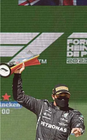  ?? AFP PIC ?? Mercedes-AMG Petronas driver Lewis Hamilton celebrates on the podium after winning the Portuguese Grand Prix on Sunday.