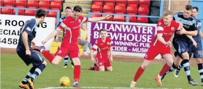  ?? 030417SALB­ION_02 ?? Blasted Ross Kavanagh shoots for goal watched by Blair Henderson