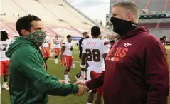  ?? MATT GENTRY The Roanoke Times ?? UM coach Manny Diaz, left, says his defensive players understand ‘that if we get into a close game we can beat anybody in the last 15 minutes because of our tempo and ability to wear people down [with] our conditioni­ng level.’