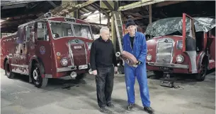  ?? PHOTOS: GERARD O’BRIEN ?? Growing collection . . . Dunedin Fire Brigade Restoratio­n Society president Joe Hayde (left) and vicepresid­ent Gary Byford, who holds spare parts, stand beside two Dennis fire appliances built in the 1950s, one from Roxburgh and the other from Balclutha.