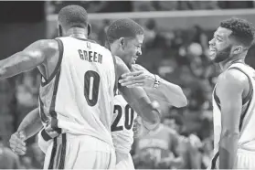  ?? NIKKI BOERTMAN/THE COMMERCIAL APPEAL ?? Memphis Grizzlies JaMychal Green, D.J. Stephens, and Andrew Harrison celebrate a run during a preseason game against the Orlando Magic at FedExForum.