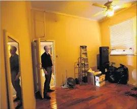  ?? Genaro Molina Los Angeles Times ?? BOB DAIGNAULT, then with the Apartment Assn. of Greater L.A., looks over an illegal apartment in 2015. Tenant advocates say many such units deserve permits.