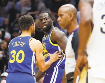  ?? Gerald Herbert / Associated Press ?? Warriors forward Draymond Green, who is one of the league leaders in technical fouls, is restrained by Stephen Curry after being called for a technical for yelling at an official.