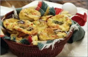  ?? ALL PHOTOS BY RICHARD DREW — THE ASSOCIATED PRESS ?? Baked muffin frittatas with asparagus and mushrooms