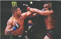  ?? GETTY IMAGES ?? Gilbert Burns, left, is now in the UFC welterweig­ht title picture after Saturday’s five-round decision over Tyron Woodley in Las Vegas.