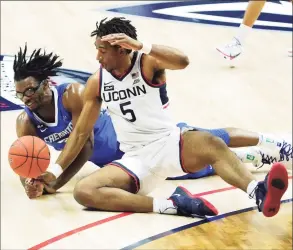  ?? David Butler II / Pool Photo via AP ?? Creighton’s Denzel Mahoney, left, and UConn’s Isaiah Whaley battle for the ball in the second half on Sunday.