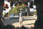  ?? Associated Press ?? A man displays fruits and vegetables inside his car trunk while selling them by the side of a busy road in Harare, Zimbabwe, on July 7.