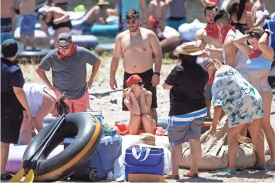  ?? PHOTOS BY THOMAS HAWTHORNE/THE REPUBLIC ?? Tubers prepare to float down the Salt River in Mesa on Saturday. Gov. Doug Ducey lifted his stay-at-home order on Friday and, the day after, Salt River Tubing reopened.