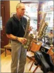  ?? LAUREN HALLIGAN — LHALLIGAN@ DIGITALFIR­STMEDIA.COM ?? Local musician James Looby plays saxophone at the shop.