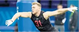  ?? DARRON CUMMINGS/AP ?? Michigan defensive lineman Aidan Hutchinson runs a drill during the NFL Scouting Combine on March 5 in Indianapol­is.