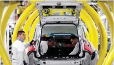  ?? — Reuters ?? Employees of Fiat SPA work on new car ‘Panda’ at the Fiat plant in Pomigliano D’arco, near Naples, Italy.