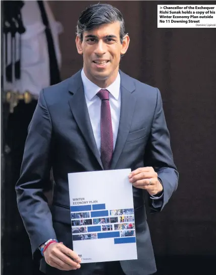  ?? Dominic Lipinski ?? Chancellor of the Exchequer Rishi Sunak holds a copy of his Winter Economy Plan outside No 11 Downing Street