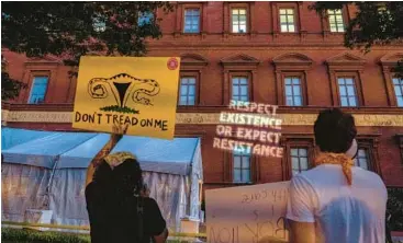  ?? GEMUNU AMARASINGH­E/AP 2022 ?? Abortion-rights protesters carry posters and project a message during an event last summer sponsored by the influentia­l group Susan B. Anthony Pro Life America at the National Building Museum in Washington.