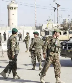  ??  ?? BAGRAM, Afghanista­n: Afghanista­n’s National Army soldiers block the main road to the Bagram Airfield’s main gate yesterday. — AP